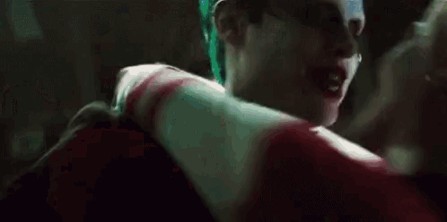 a man and a woman are dancing together in a dark room .