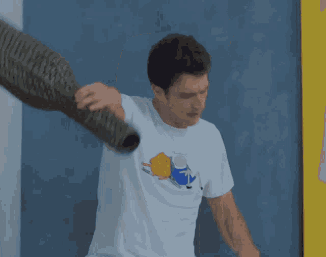 a man wearing a white t-shirt with a picture of finn and jake on it