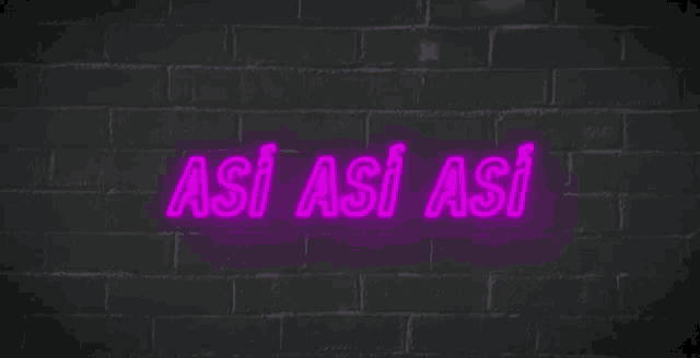 a neon sign that says así así así on a brick wall .