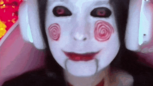 a close up of a person wearing headphones and a scary mask .