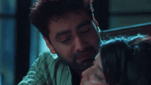 a man is hugging a woman who is laying down