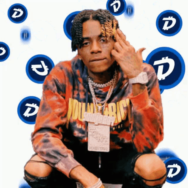 a man wearing a red tie dye sweatshirt that says " volunteer "