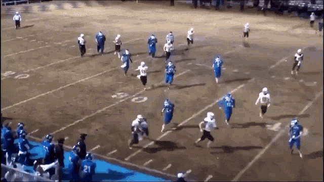 a group of football players are running on a field with the number 21 on the back of their jersey