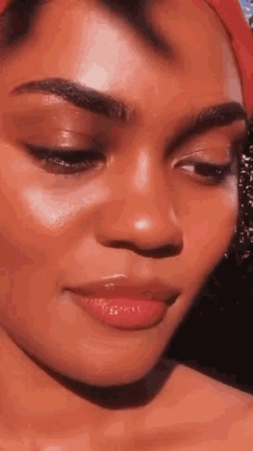 a close up of a woman 's face with a red headband on