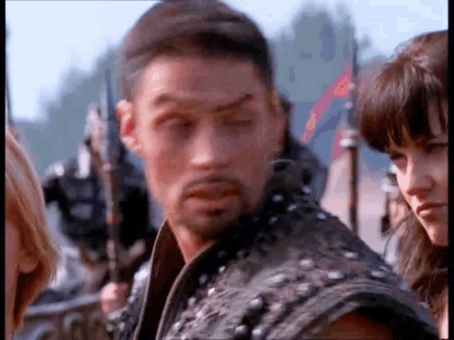 a man and a woman are standing next to each other in a field .