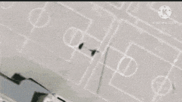 an aerial view of a school building with a basketball court drawn on the ground .