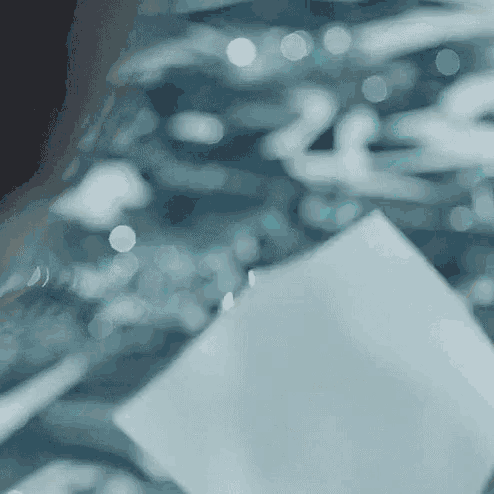 a close up of a person holding a piece of paper .