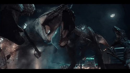 a group of dinosaurs are fighting in a dark room .