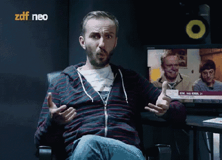 a man sitting in front of a zdf neo television
