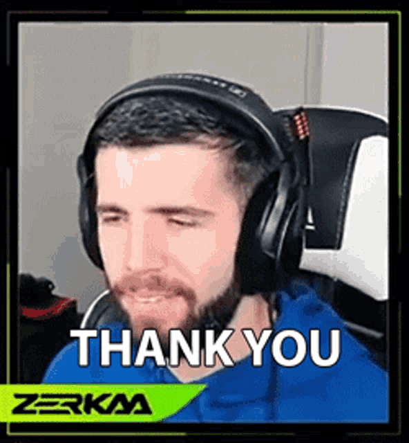 a man wearing headphones is sitting in a chair and saying thank you