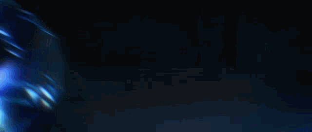 a blurred image of a blue light in a dark room