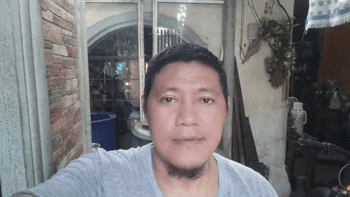 a man with a beard is taking a selfie