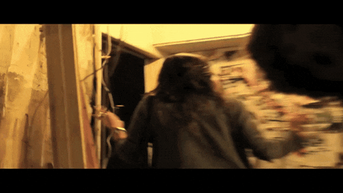 a blurry picture of a woman walking through a door