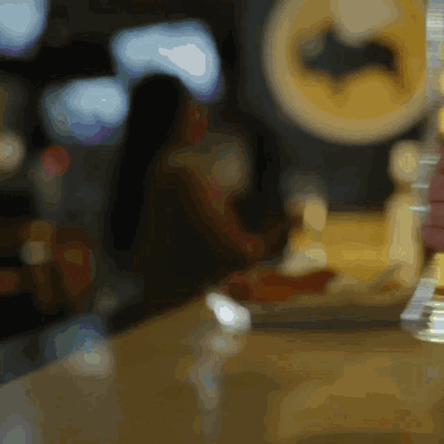 a blurry photo of a batman logo on a wall