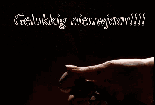 a person is spraying something with the words " gelukkig nieuwjaar " written on the bottom
