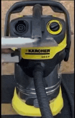 a karcher vacuum cleaner is being used to clean a piece of paper .