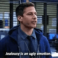 a man in a blue jacket and tie is saying `` jealousy is an ugly emotion '' .