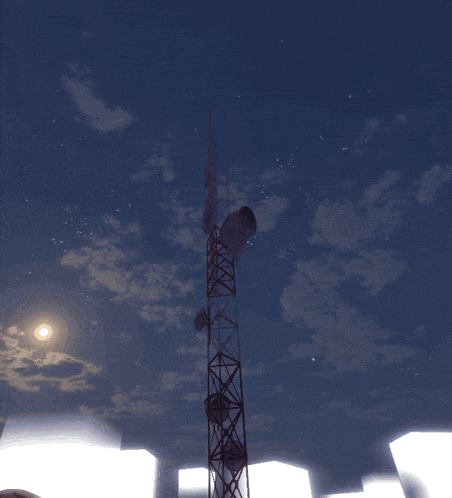 a very tall tower with antennas on it against a blue sky