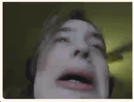 a close up of a man 's face with his mouth open .