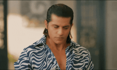 a man wearing a blue and white striped shirt