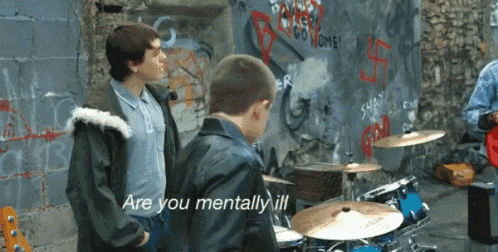 a man playing drums says " are you mentally ill " to another man