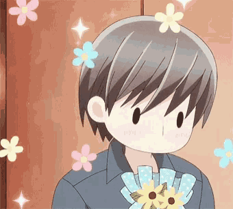 a boy is holding a bouquet of flowers in his hand surrounded by flowers .