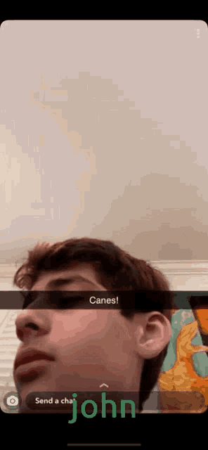 a snapchat of a young man with the caption canes send a chat john