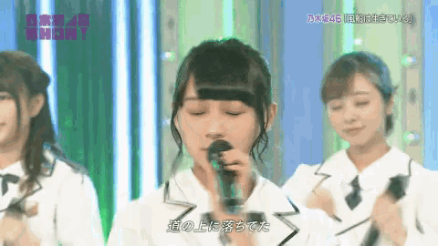 a girl singing into a microphone with the word show on the bottom right