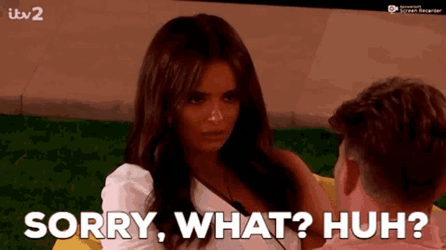 a woman is sitting next to a man and says sorry what huh ..