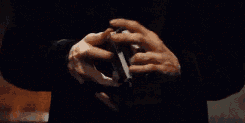 a close up of a person holding a stack of playing cards .