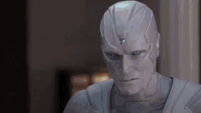 a close up of a man in a white suit with a blue eye and a helmet .