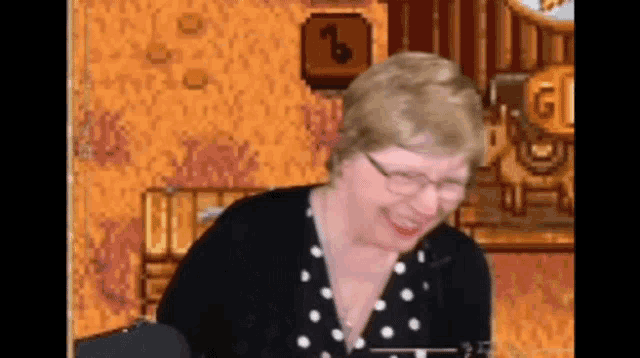 an elderly woman wearing glasses is smiling in front of a pixelated background with the number 3 on it