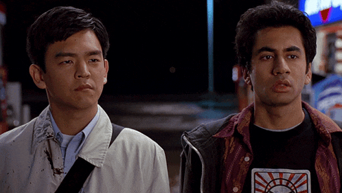 two men are standing next to each other with one wearing a t-shirt that says ' sunrise '
