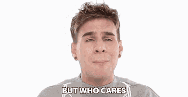 a young man is making a funny face and saying `` but who cares '' while wearing a sweater .