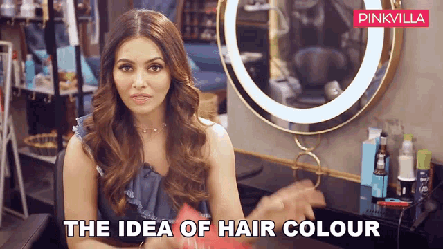 a woman in a salon with the words " the idea of hair colour " below her