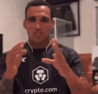 a man wearing a shirt with the word crypto.com on it