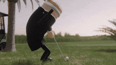 a cartoon character is swinging a golf club at a golf ball on a golf course