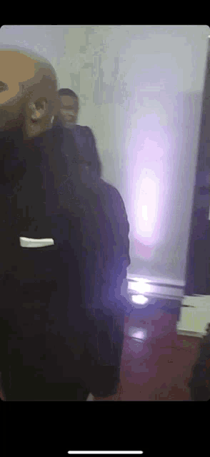 a man in a black jacket with the word essential on the back