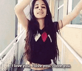 a woman is standing on a balcony with her arms outstretched and says i love you i love you i love you