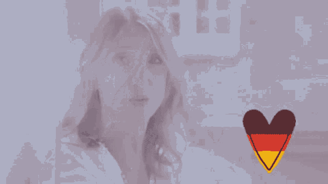 a woman is looking out a window with a heart in the foreground
