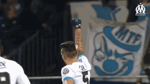 a soccer player with the number 5 on his jersey is celebrating