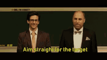 two men in suits and bow ties are standing in front of a blackboard and one of them says " aim straight for the target "