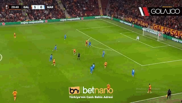 a soccer game is being played in front of a banner that says " galatasaray "