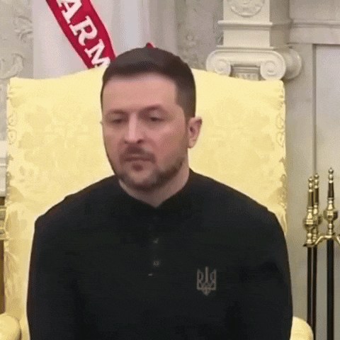 a man is sitting in a chair with a flag behind him that says army .