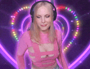 a woman in a pink top and headphones is standing in front of a purple heart