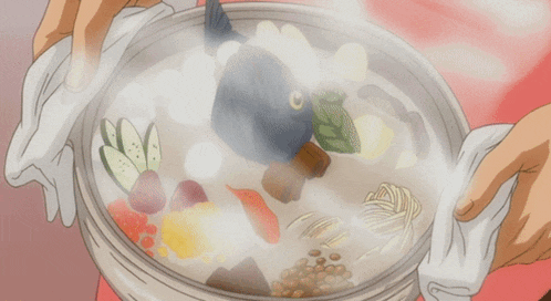 a person is holding a pot of food with a fish on top