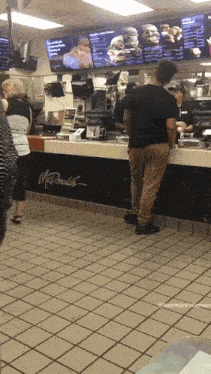 a man standing at a mcdonalds counter