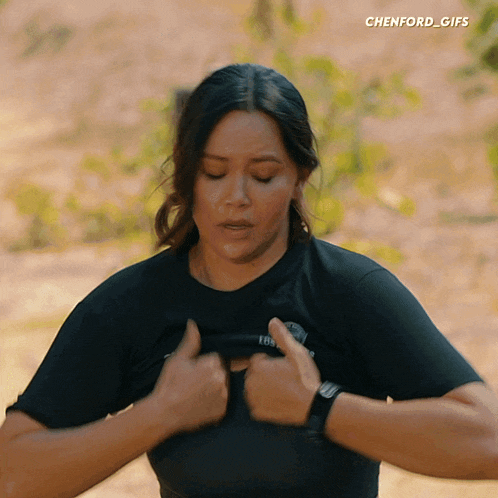 a gif of a woman taking off her shirt with chenford_gifs in the corner