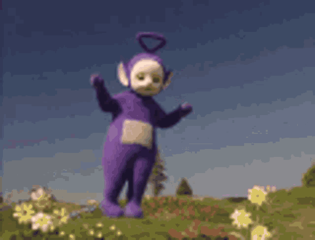 a purple teletubbies character standing in a field of flowers .