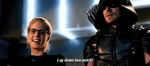 a man and a woman are standing next to each other and the man is saying lay down bee-yotch